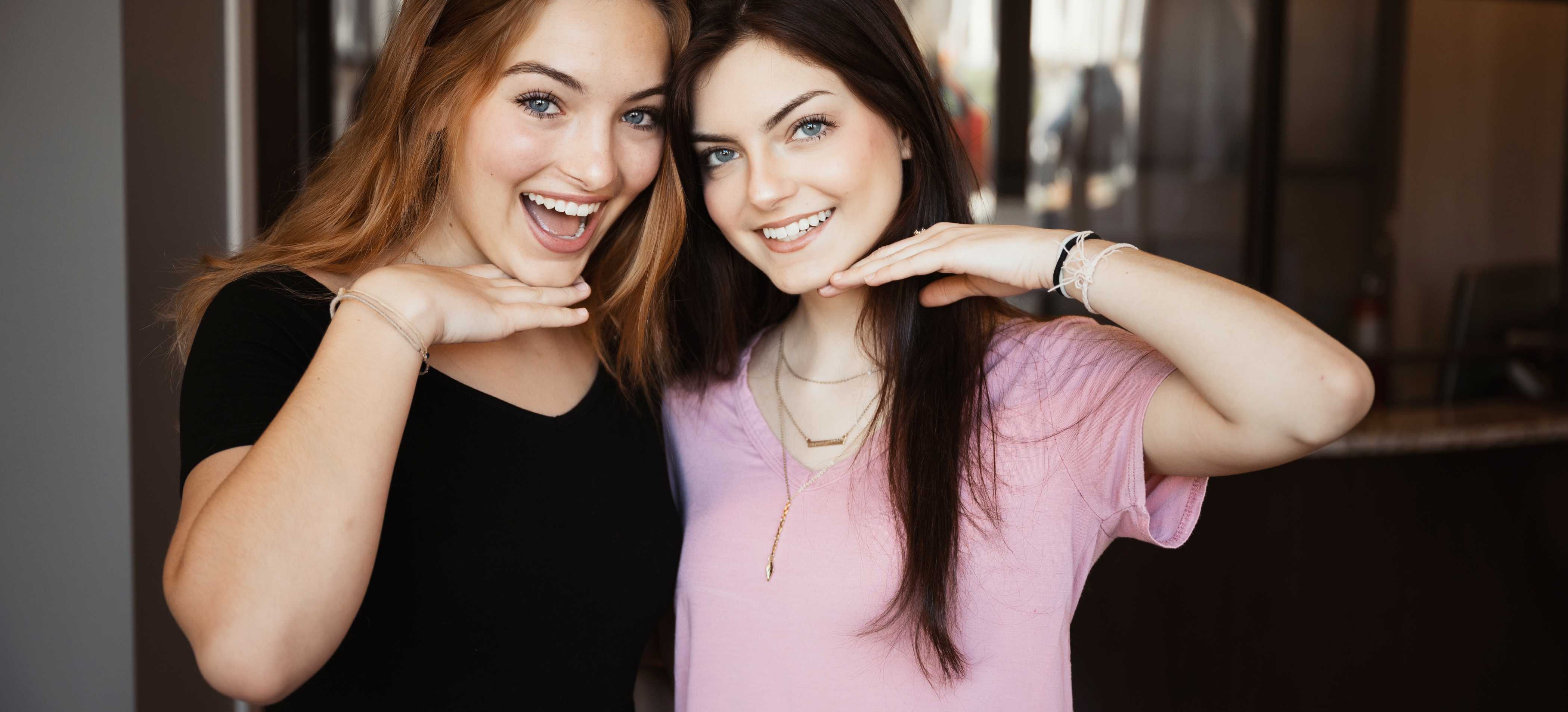 Two patients of Smile Sculptors smiling at the camera